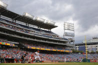 Washington Nationals' Trea Turner stands in the batter's box in front of Philadelphia Phillies catcher Andrew Knapp and umpire Vic Carapazza in the first inning of a baseball game, Thursday, Sept. 26, 2019, in Washington. (AP Photo/Patrick Semansky)