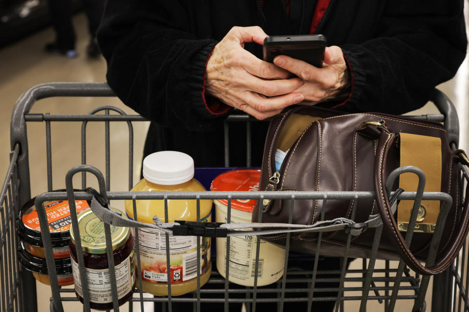 Pauline Doty consults her shopping list at a Food Lion in Columbia, S.C., on Jan. 27, 2023. (Travis Dove for NBC News)