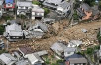 <p>Houses are damaged by mudslide following heavy rains in Kure city, Hiroshima prefecture, southwestern Japan, July 7, 2018. Heavy rainfall hammered southern Japan for the third day, prompting new disaster warnings on Kyushu and Shikoku islands Sunday. (Photo: Koji Harada/Kyodo News via AP) </p>