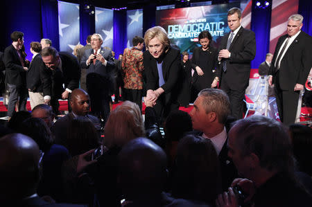 Democratic U.S. presidential candidates fomer Governor Martin O'Malley (L) and former Secretary of State Hillary Clinton (R) shake hands with the audience January 17, 2016. REUTERS/Randall Hill