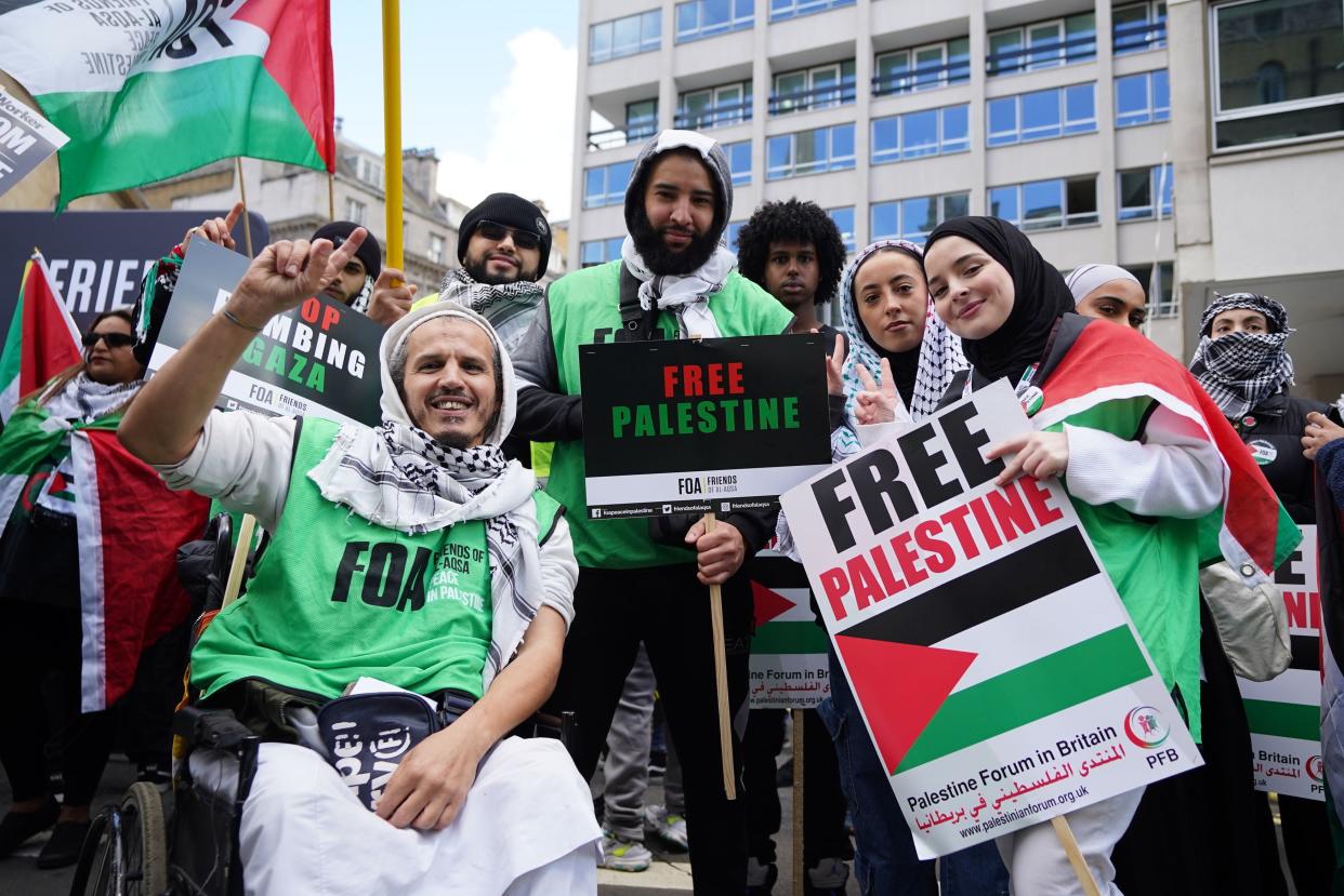 Protestors holding Free Palestine placards during a March for Palestine rally in London (PA)