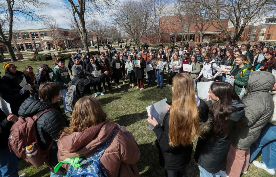 Students gather in front of Main Hall at St. Norbert College in De Pere on Wednesday. They were protesting recently announced layoffs at the college.