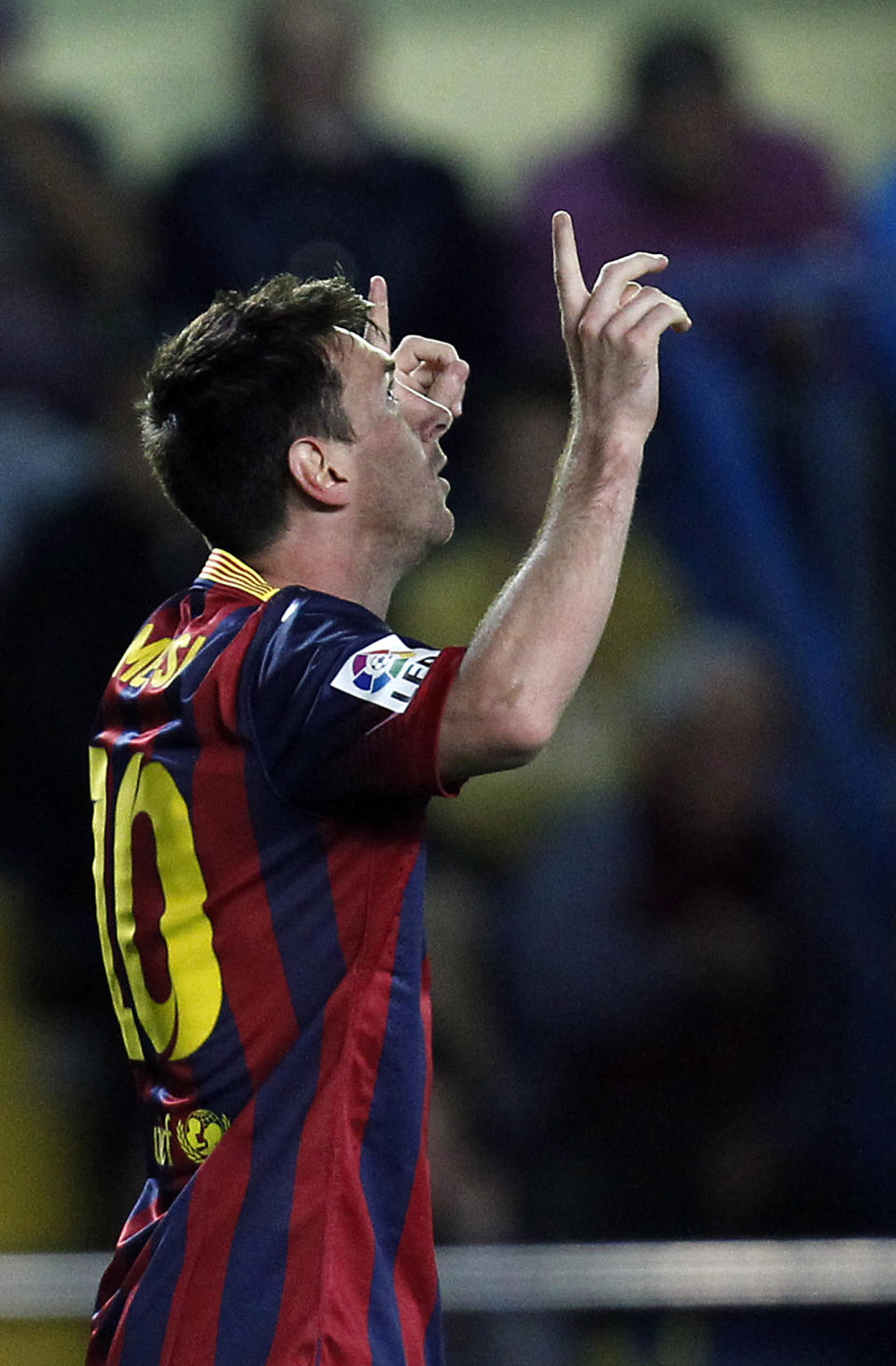 Barcelona's Lionel Messi from Argentina celebrates after scoring against Villarreal during a Spanish La Liga soccer match at the Madrigal stadium in Villarreal, Spain, on Sunday, April 27, 2014. (AP Photo/Alberto Saiz)