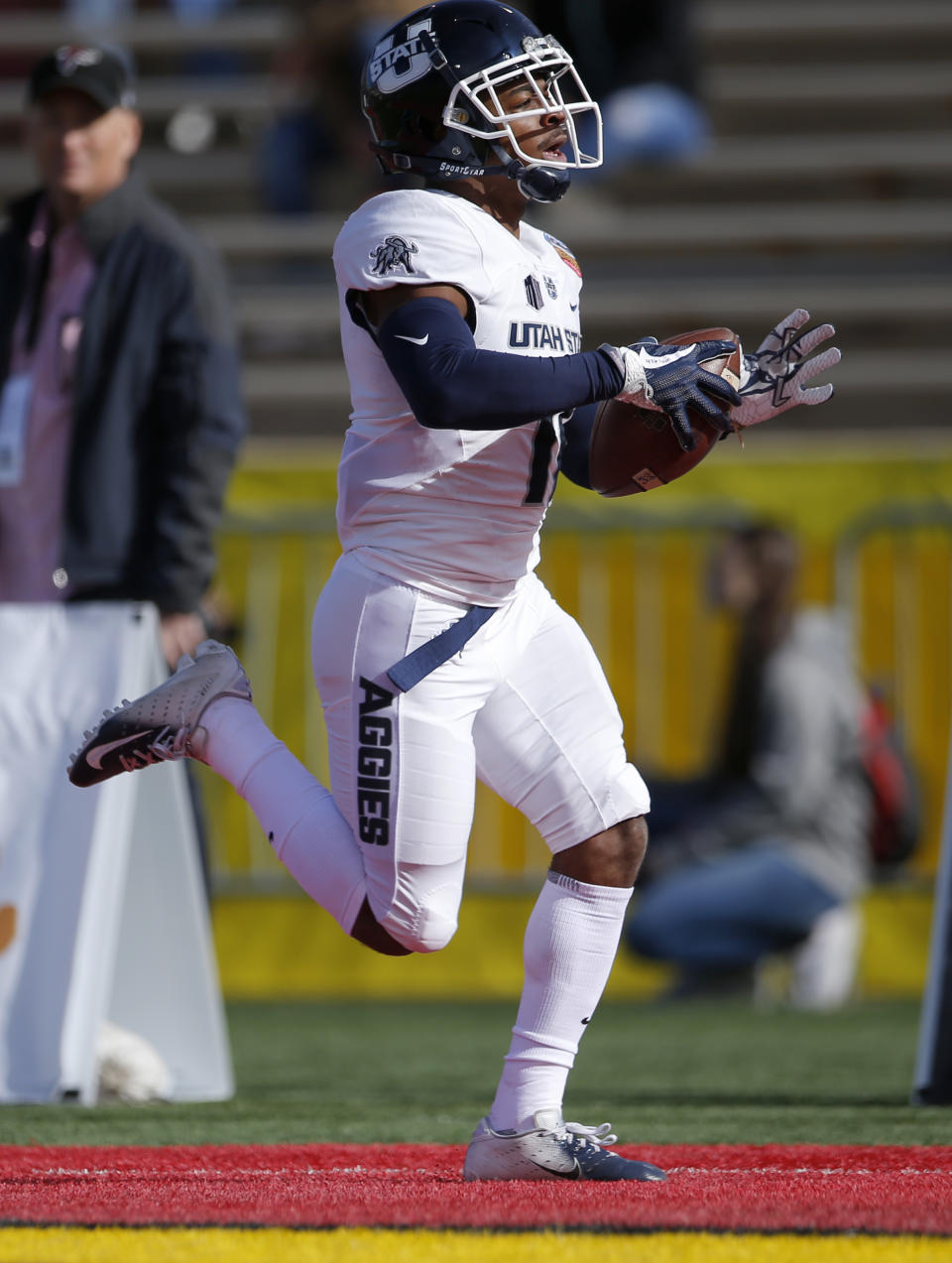 Utah State wide receiver Aaren Vaughns scores a touchdown against North Texas during the first half of the New Mexico Bowl NCAA college football game in Albuquerque, N.M., Saturday, Dec. 15, 2018. (AP Photo/Andres Leighton)