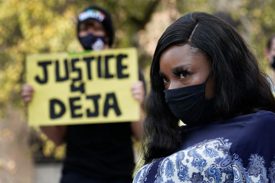 Deja Stallings listens during a news conference outside city hall Thursday, Oct. 8, 2020, in Kansas City, Mo. Protesters have occupied the lawn and plaza in front of city hall more than a week demanding the resignation of police chief Rick Smith and the officer who knelt on Stallings' back while arresting the pregnant woman last week. (AP Photo/Charlie Riedel) ORG XMIT: MOCR108