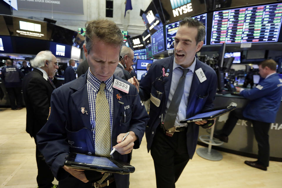 Traders Robert Charmak, left, and Gregory Rowe work on the floor of the New York Stock Exchange, Tuesday, Oct. 24, 2017. U.S. stocks are edging higher Tuesday morning as construction equipment maker Caterpillar and Post-it note maker 3M lead a rally in industrial companies, while banks are climbing along with interest rates. (AP Photo/Richard Drew)