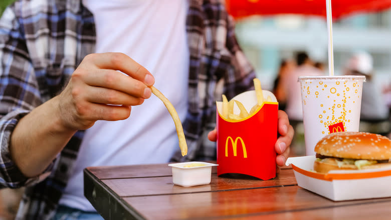 dipping McDonald's fries into sauce