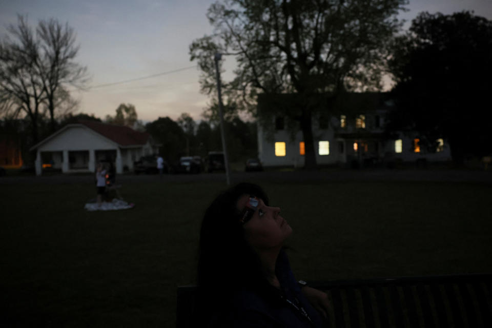 Debbie Ward looks to the sky during the total solar eclipse, where the moon blots out the sun, at Wheelock Academy, in Millerton, OK, U.S. April 8, 2024.