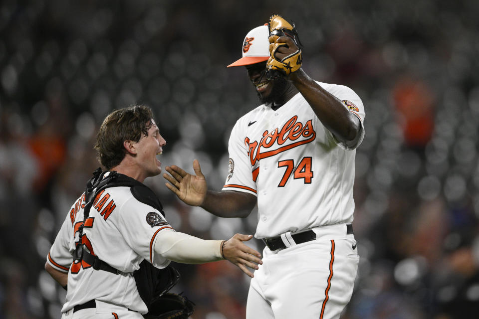 Baltimore Orioles relief pitcher Felix Bautista (74) and catcher Adley Rutschman (35) celebrate after a baseball game against the Toronto Blue Jays, Monday, Aug. 8, 2022, in Baltimore. (AP Photo/Nick Wass)