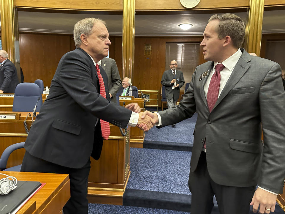 North Dakota Republican House Majority Leader Mike Lefor, left, shakes hands with Democratic House Minority Leader Zac Ista after the state House of Representatives adjourned on Wednesday, Oct. 25, 2023, at the end of the Legislature's special session at the state Capitol in Bismarck, N.D. Republican Gov. Doug Burgum had called the special session after a state Supreme Court ruling in September that had voided a major budget bill. Lawmakers came back to Bismarck to fix the budget mess. (AP Photo/Jack Dura