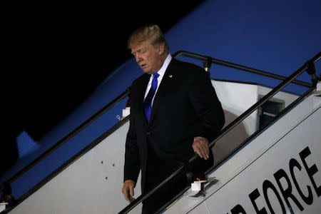 U.S. President Donald Trump disembarks Air Force One as he arrives in Singapore June 10, 2018. REUTERS/Jonathan Ernst