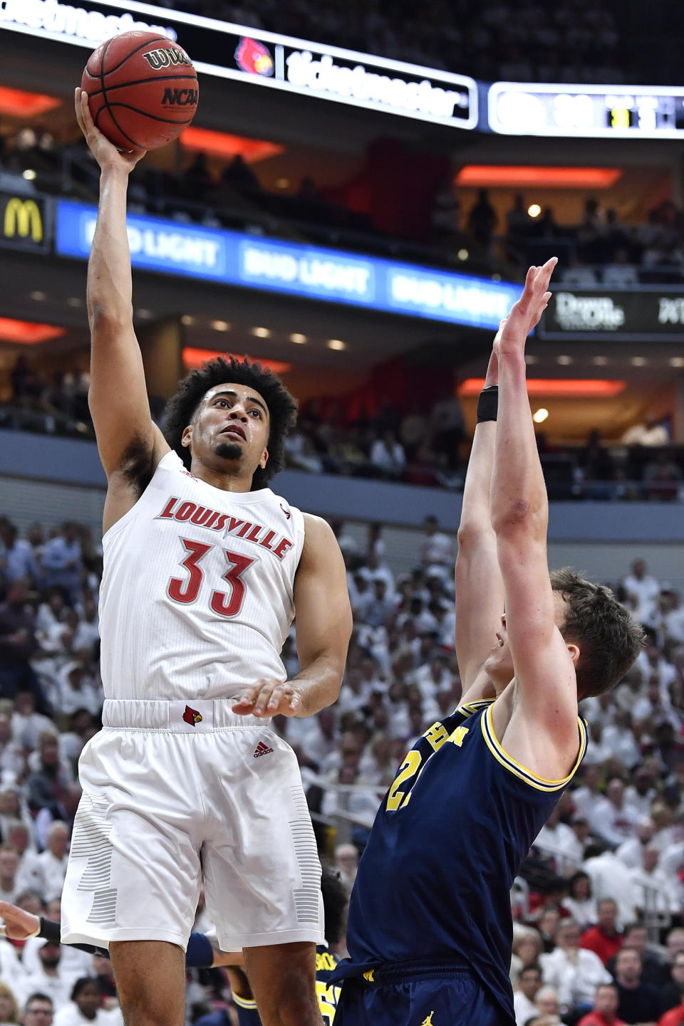 Louisville forward Jordan Nwora (33) shoots over the defense of Michigan guard Franz Wagner (21) during the second half of an NCAA college basketball game in Louisville, Ky., Tuesday, Dec. 3, 2019. Louisville won 58-43. (AP Photo/Timothy D. Easley)