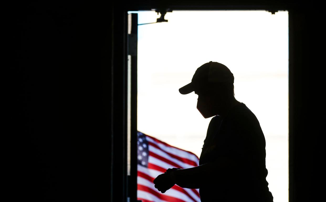 A voter puts on their "I Voted" bracelet in Louisville inside the Barrett Traditional Middle School gym on May 17, 2022.