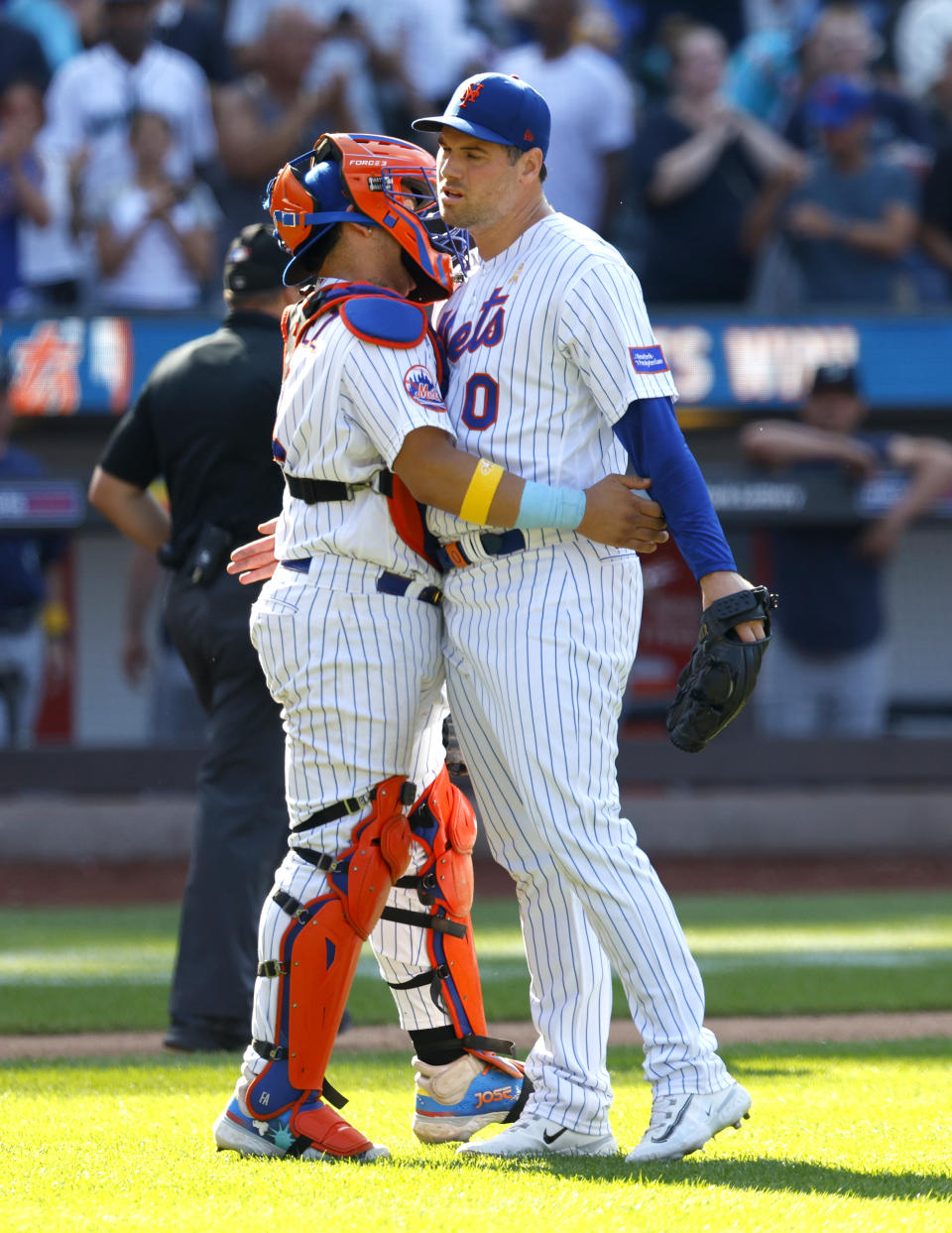 New York Mets' Francisco Alvarez (4) and Adam Ottavino (0) hug after a baseball game against the Seattle Mariners, Sunday, Sept. 3, 2023, in New York. (AP Photo/Noah K. Murray)