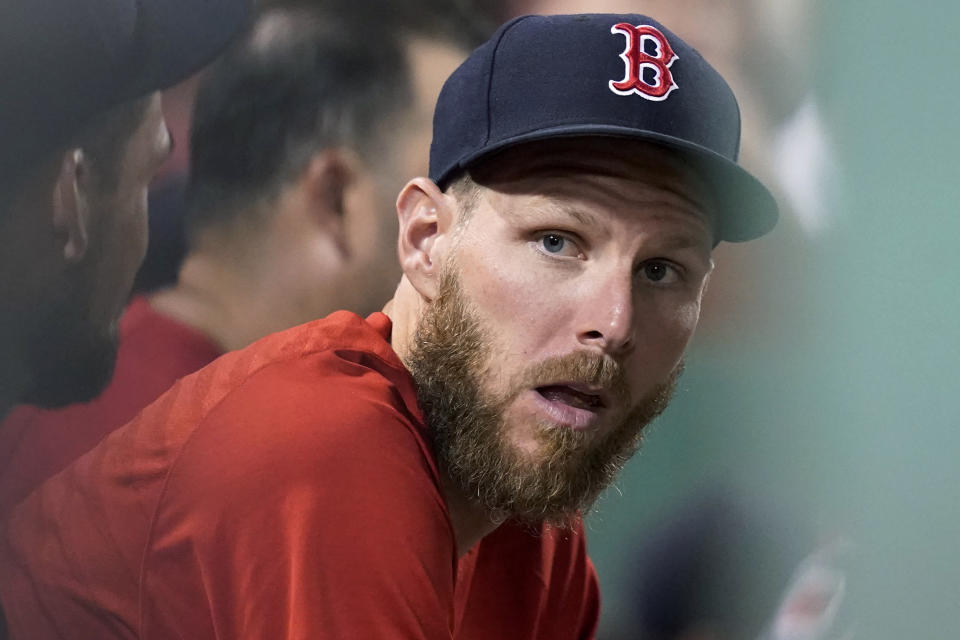 Boston Red Sox pitcher Chris Sale sits in the dugout during the fifth inning of the team's baseball game against the Baltimore Orioles at Fenway Park, Friday, Aug. 13, 2021, in Boston. (AP Photo/Elise Amendola)