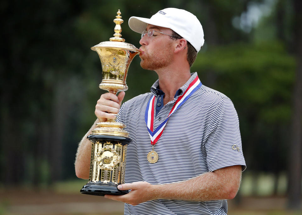 Andy Ogletree poses with the Havemeyer Trophy following his win at the USGA Amateur Golf Championship at the Pinehurst Country Club in Pinehurst, N.C., Sunday, Aug. 18, 2019. (AP Photo/Karl B DeBlaker)