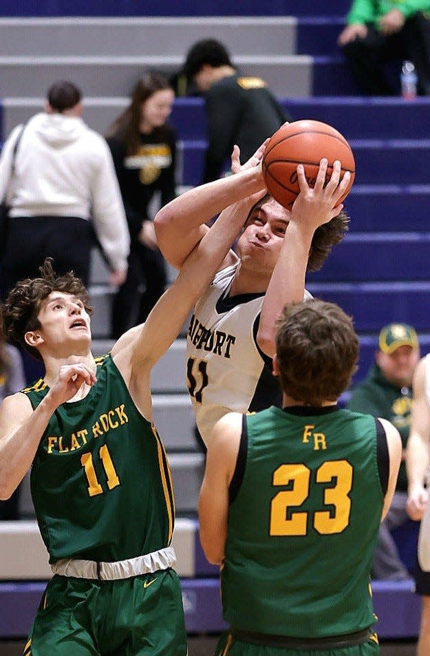 Airport's Cooper Nye works inside against Odin Nemeth (11) and Graham Junge of Flat Rock Tuesday night. Flat Rock won 57-44.