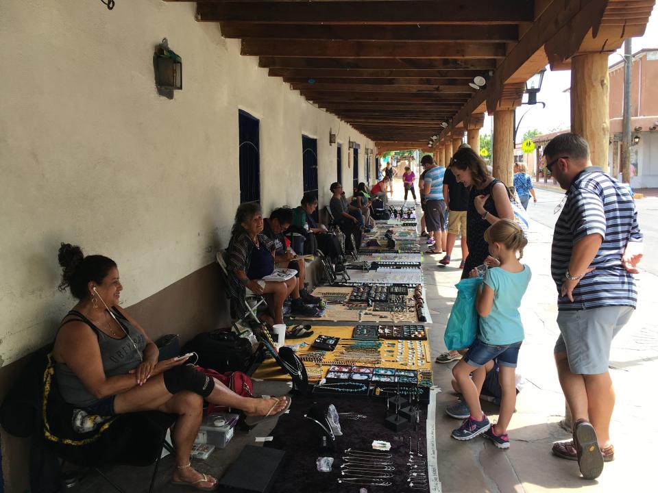 In this Wednesday, June 22, 2016 photo, American Indian jewelers sell their artwork in the plaza of Albuquerque's Old Town, N.M. The nation's Hispanic population grew by 2.2 percent to 56.6 million, and New Mexico had the largest percentage of Latinos in the country at 48 percent, according to new information from the U.S. Census Bureau. Data also showed New Mexico has one of the highest percentages of minorities in the country.