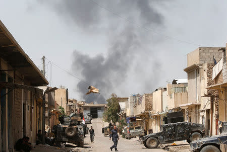 Smoke rises above the old city as Iraqi forces fight Islamic State militants in western Mosul, Iraq, April 22, 2017. REUTERS/Muhammad Hamed