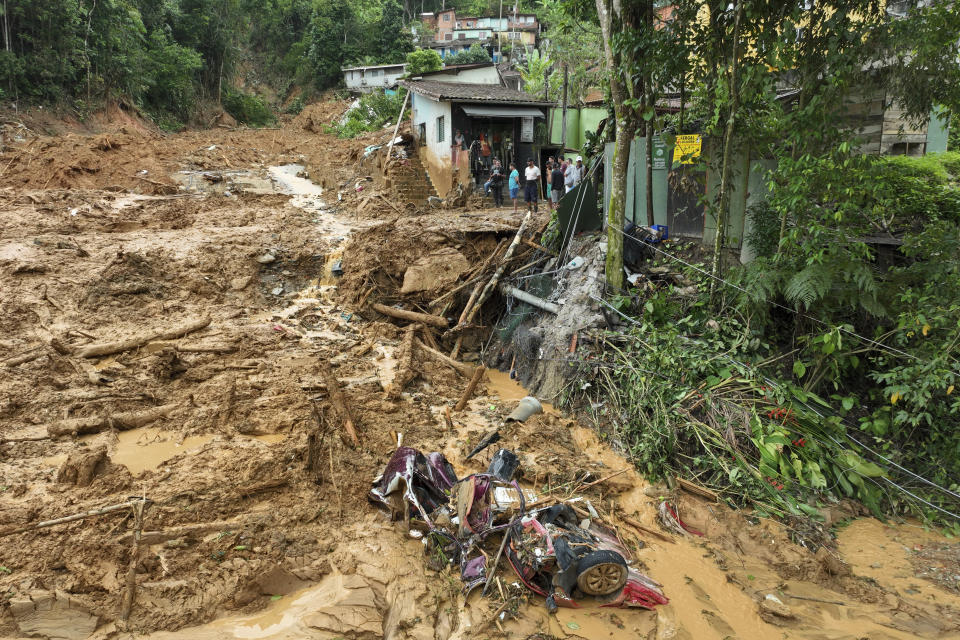 A crumpled vehicle lays in the mud after a deadly landslide triggered by heavy rains destroyed the area near Juquehy beach in the coastal city of Sao Sebastiao, Brazil, Monday, Feb. 20, 2023. (AP Photo/Andre Penner)