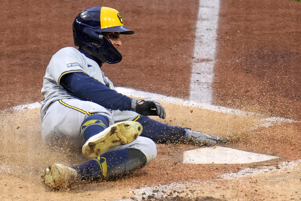 Milwaukee Brewers' Sal Frelick scores on a single by William Contreras off Pittsburgh Pirates relief pitcher Luis L. Ortiz during the third inning of a baseball game in Pittsburgh, Wednesday, April 24, 2024. (AP Photo/Gene J. Puskar)