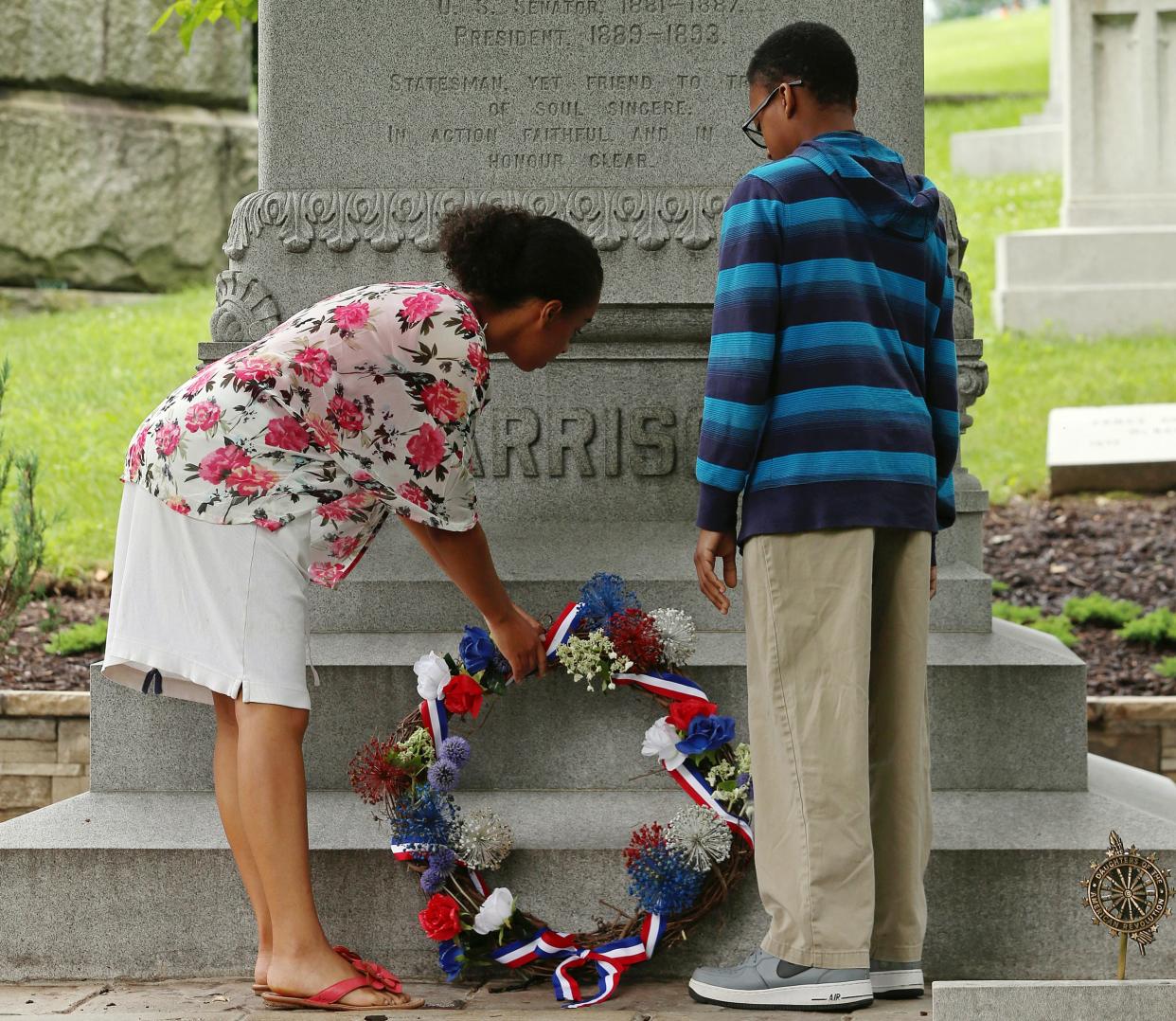 From left, Elisabeth Reese, 16, and Edwin Girton, 13, place a wreath on twenty-third president of the United States Benjamin Harrison's grave, Friday, July 3, 2015, at Crown Hill Cemetery, Indianapolis, Ind.