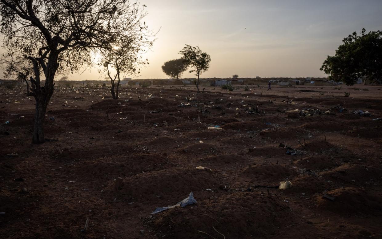 Children's graves in a makeshift cemetery on the outskirts of an informal refugee camp in Adre, Chad