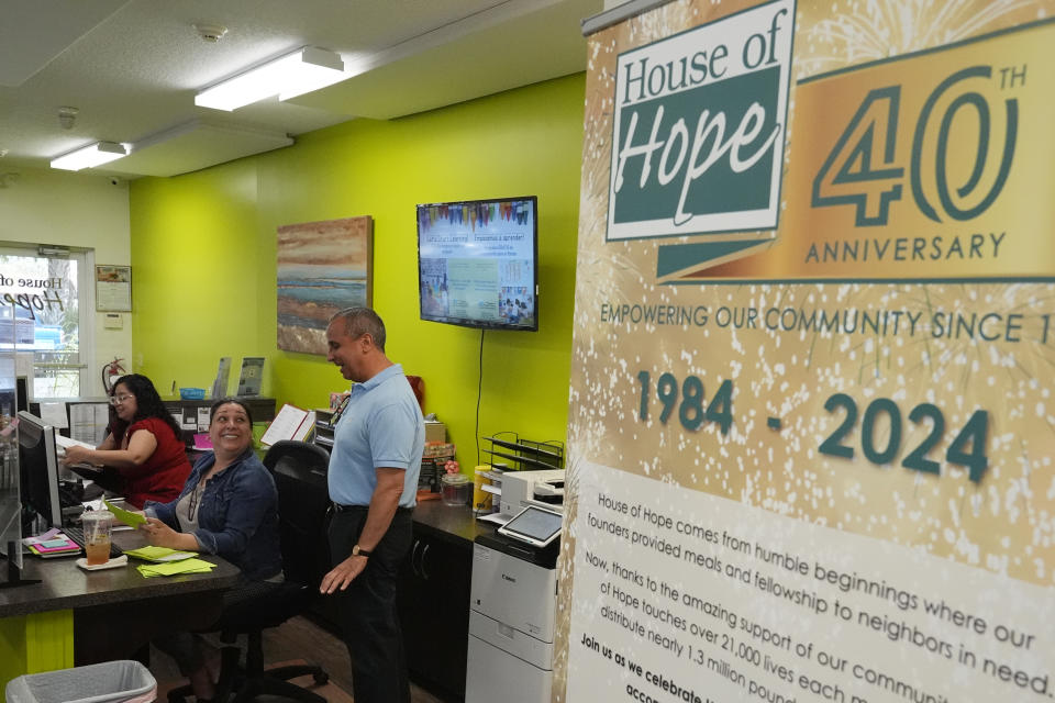 Rob Ranieri, CEO of House of Hope, talks to a receptionist, Tuesday, May 21, 2024, in Stuart, Fla. The Community Foundation Martin-St. Lucie counties has overhauled its approach to disaster response by creating a permanent fund and establishing preemptive agreements with nonprofit partners like House of Hope to deploy funds to them immediately when a storm is forecasted. (AP Photo/Marta Lavandier)