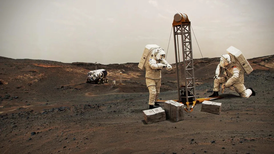 An artist concept of two astronauts in large spacesuits on Mars with a rover in the background