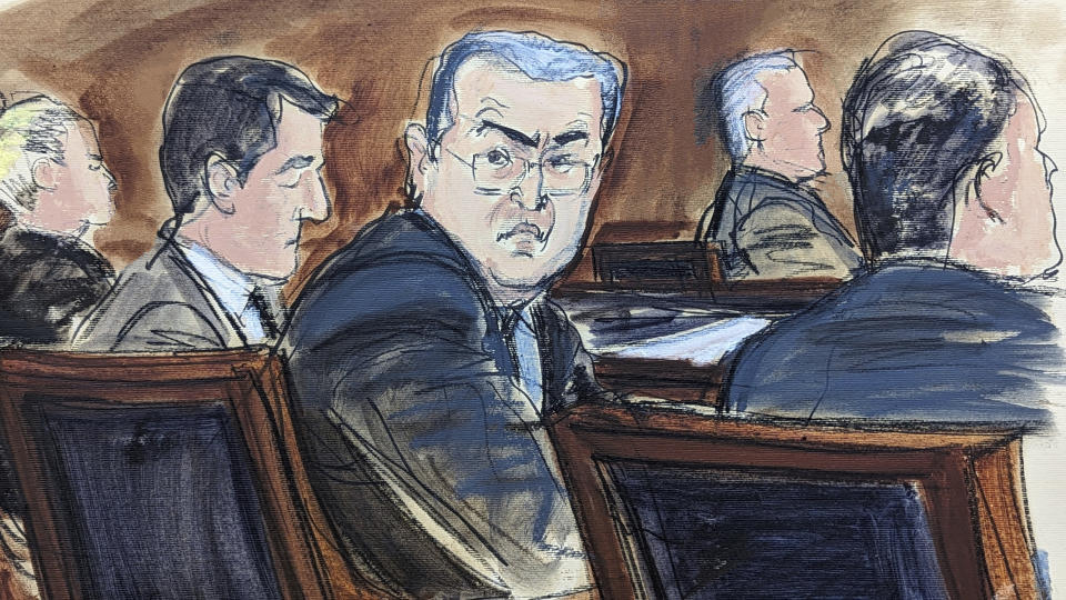 FILE - In this courtroom sketch from federal court in New York, Tuesday, Feb. 20, 2024, former Honduran President Juan Orlando Hernández, seated center at the defense table, turns to looks at prospective jurors during the jury selection process at the start of his trial. Hernández took the witness stand in his defense at his New York trial on Tuesday, March 5, denying that he teamed up with drug dealers to protect them in return for millions of dollars in bribes. (Elizabeth Williams via AP, File)