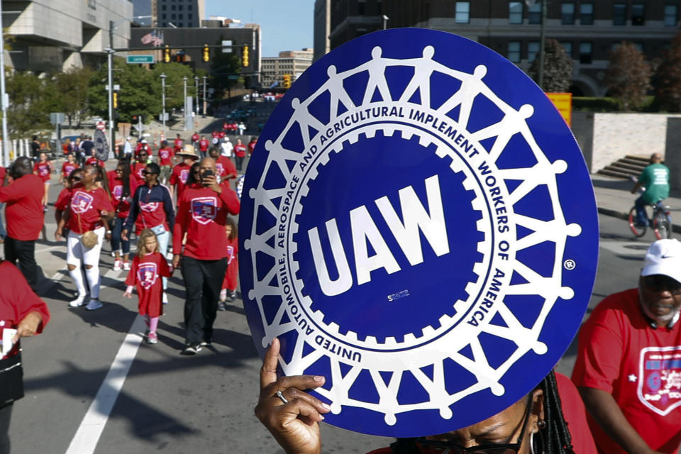 FILE - United Auto Workers members walk in the Labor Day parade in Detroit, Sept. 2, 2019. The new president of the United Auto Workers gave his strongest warning yet Friday, June 16, 2023, that the union is preparing for strikes against Detroit’s three automakers. In a Facebook Live appearance, Shawn Fain said the union is in a strong position to make major gains in talks with Stellantis, Ford and General Motors. (AP Photo/Paul Sancya, File)
