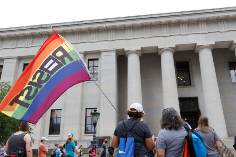 Transgender rights advocates stood outside of the Ohio Statehouse in 2021 to oppose and bring attention to an amendment to a bill that would ban transgender women from participating in high school and college women’s sports. (Stephen Zenner/Getty Images)