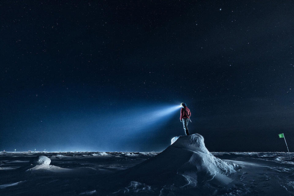 A polar bear guard stands watch on an ice ridge. (Photo: Lukas Piotrowski)