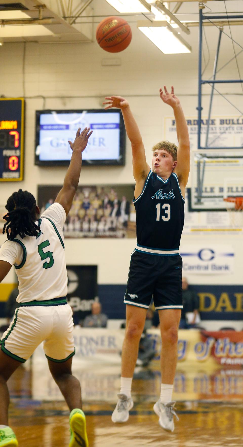 North Oldham’s Ryan Howard sinks a 3-pointer against Great Crossing’s Junius Burrell on Tuesday night.