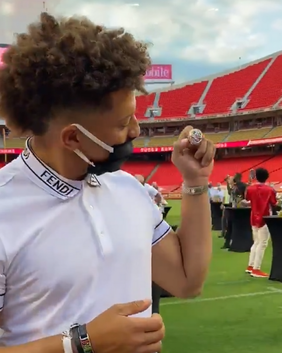 Chiefs quarterback Patrick Mahomes admires his Super Bowl LIV championship ring during a ceremony in 2020 at Arrowhead Stadium.