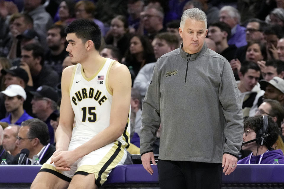 Purdue coach Matt Painter, right, stand next to center Zach Edey during the second half of the team's NCAA college basketball game against Northwestern in Evanston, Ill., Friday, Dec. 1, 2023. Northwestern won 92-88 in overtime. (AP Photo/Nam Y. Huh)