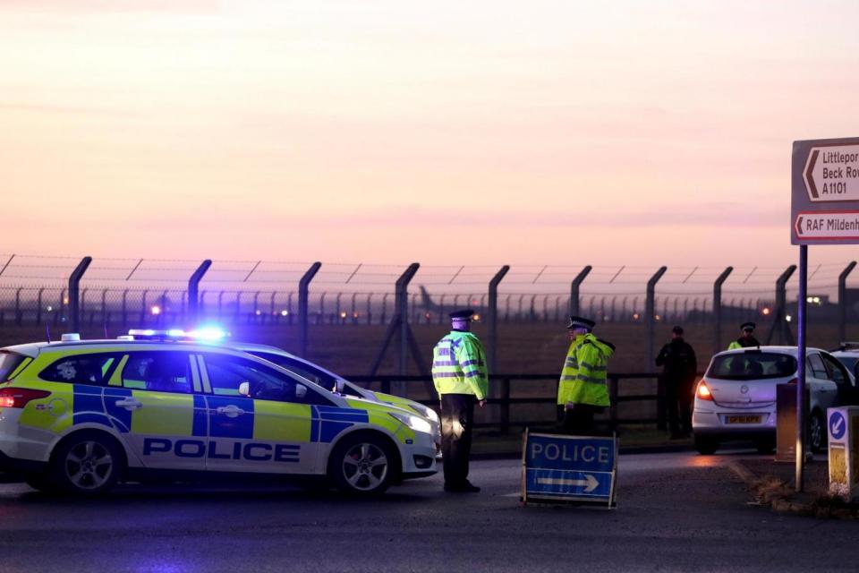 Police stand guard at the entrance to the US Air Force base at RAF Mildenhall (REUTERS)