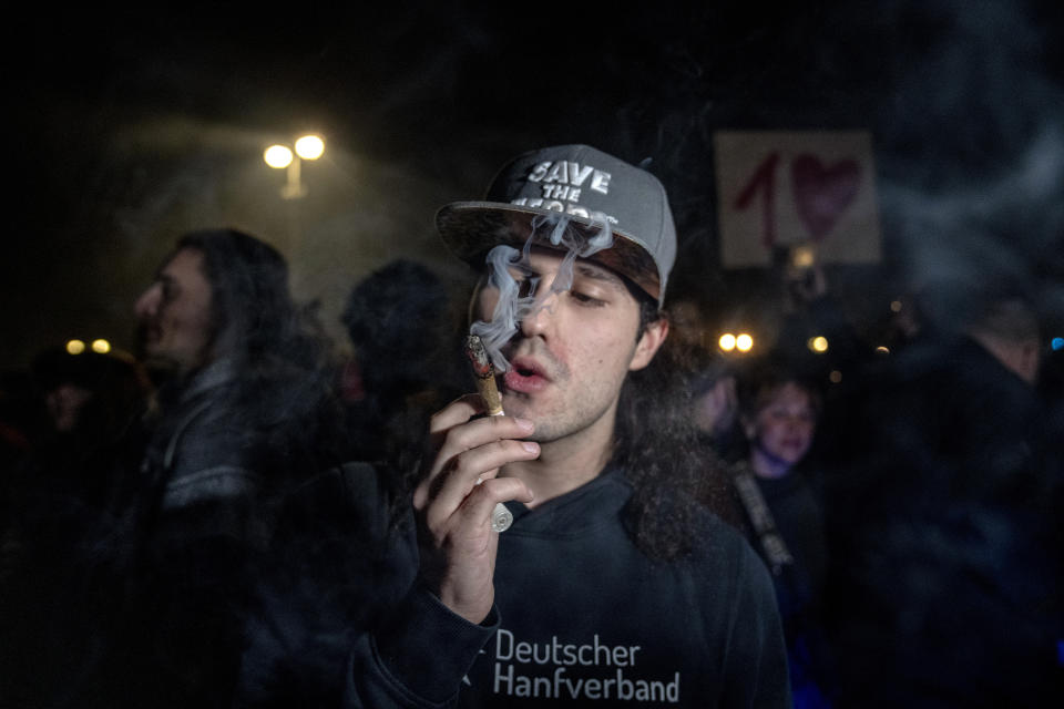 A man takes a puff from a marijuana cigarette in front of the Brandenburg Gate during the 'Smoke-In' event in Berlin, Germany, Monday, April 1, 2024. Starting 1 April, Germany has legalised cannabis for personal use. As per the new law, Adults aged 18 and over will be allowed to carry up to 25 grams of cannabis for their own consumption. (AP Photo/Ebrahim Noroozi)