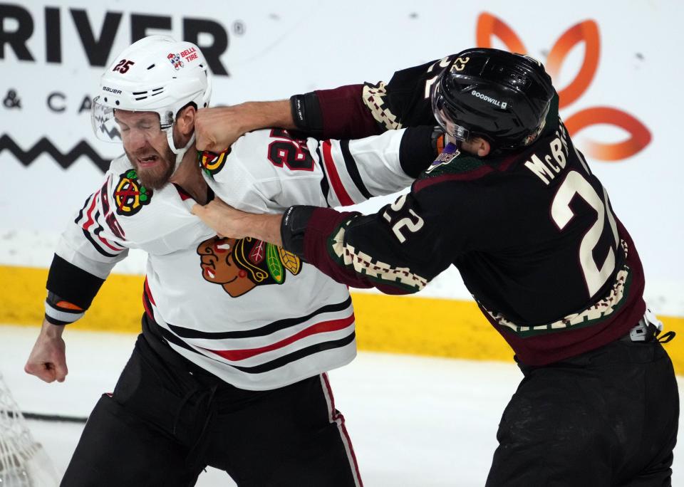 Feb 28, 2023; Tempe, Arizona, USA; Chicago Blackhawks defenseman Jarred Tinordi (25) and Arizona Coyotes center Jack McBain (22) fight during the first period at Mullett Arena. Mandatory Credit: Joe Camporeale-USA TODAY Sports