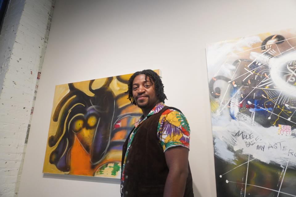 Clarence Edward, owner of Cecret by CE Gallery, curated 33 of George Clinton's paintings for the exhibition within the May Hosiery Mills.