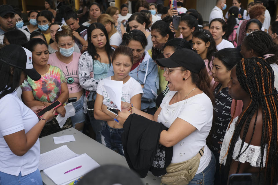 A woman reads a list of inmates who survived a deadly fire at a jail in Tulua, Colombia, Tuesday, June 28, 2022. Authorities say at least 49 people were killed after the fire broke out during what appeared to be an attempted riot early Tuesday. (AP Photo/Juan Jose Horta)