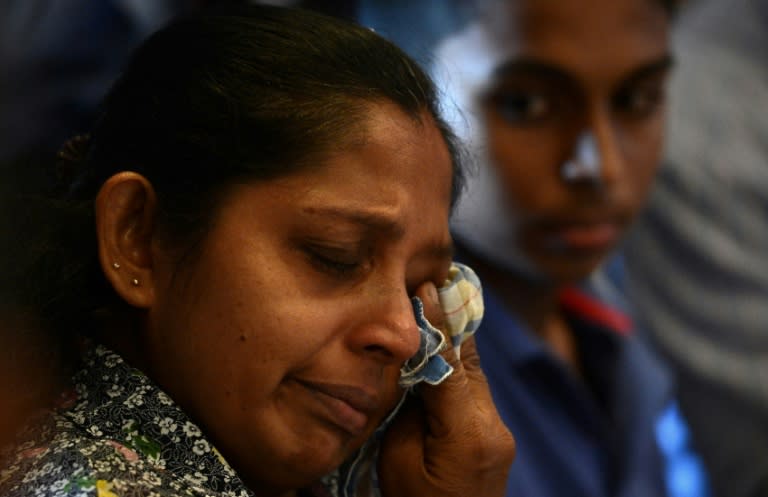 Anupama Sanjeewani, a relative of Sri Lankan hostage Janaka Shamendra uses a handkerchief during a press conference in Colombo on March 16, 2017