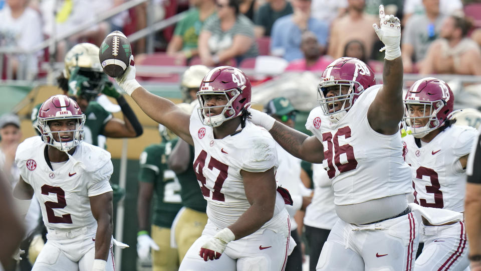 Alabama defensive lineman James Smith (47) celebrates after recovering a fumble by South Florida during the first half of an NCAA college football game Saturday, Sept. 16, 2023, in Tampa, Fla. Looking on is defensive back Caleb Downs (2) and defensive lineman Tim Keenan III (96). (AP Photo/Chris O'Meara)