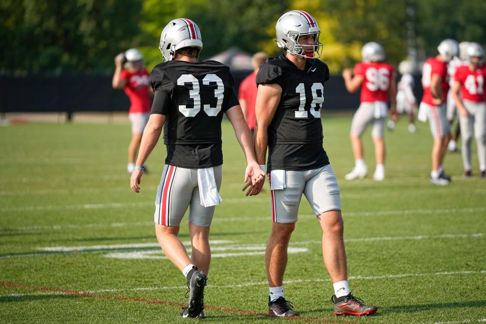 Aug 8, 2024; Columbus, Ohio, USA; Ohio State Buckeyes quarterback Devin Brown (33) high fives Will Howard (18) during football practice at the Woody Hayes Athletic Complex.