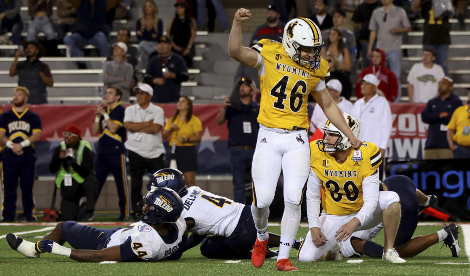 Wyoming's John Hoyland (46) pumps his fist after hitting a field goal to give the team a win over Toledo during the Arizona Bowl NCAA college football game Saturday, Dec. 30, 2023, in Tucson, Ariz. (Kelly Presnell/Arizona Daily Star via AP)