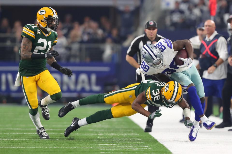 <p>Dez Bryant #88 of the Dallas Cowboys is tackled by John Crockett #38 of the Green Bay Packers after catching a pass during the first quarter of their NFC Divisional Playoff game at AT&T Stadium on January 15, 2017 in Arlington, Texas. (Photo by Tom Pennington/Getty Images) </p>