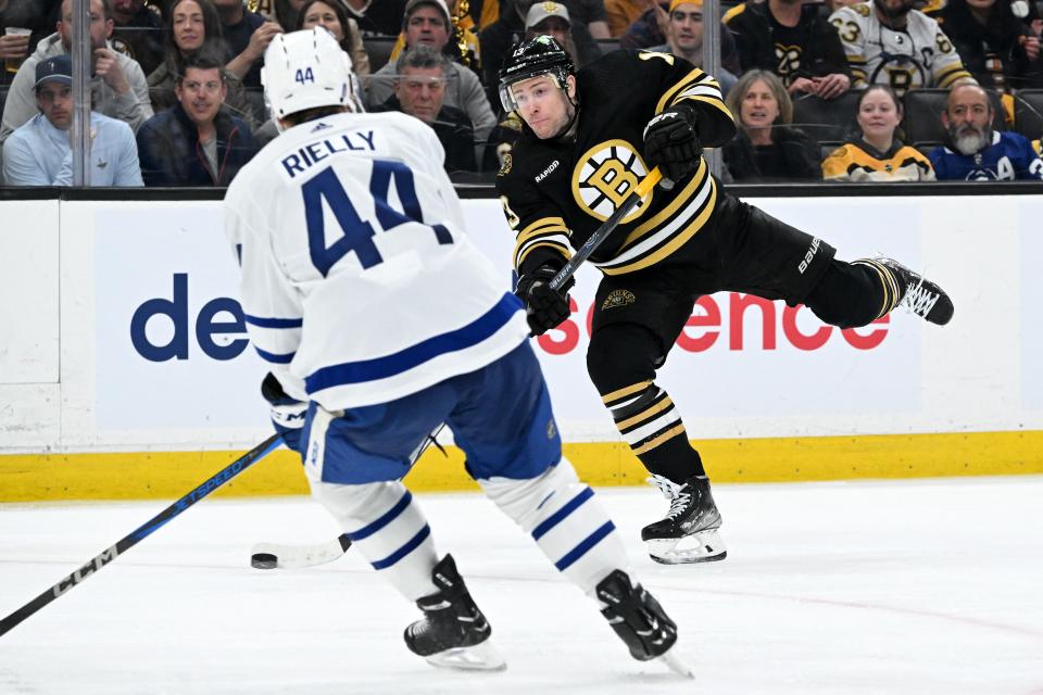 Boston center Charlie Coyle (13) takes a shot against Toronto Maple defenseman Morgan Rielly (44) during the third period of Game 2 of the first round of the 2024 Stanley Cup Playoffs at TD Garden on Monday.