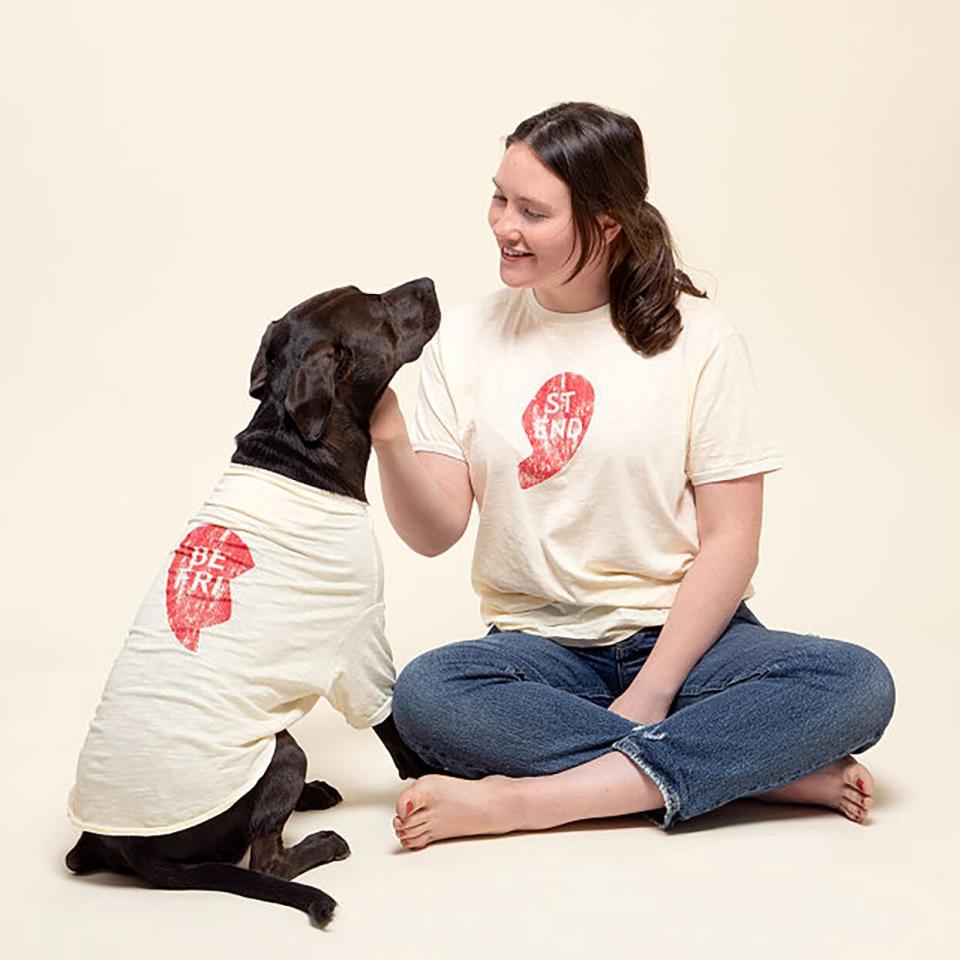 Model and dog wearing a BFF Pet Parent and Child Tee set on an off-white background