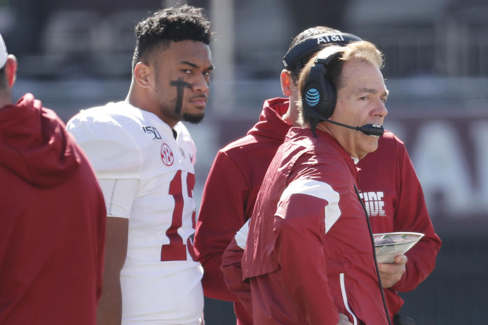Alabama quarterback Tua Tagovailoa (13) listens to instructions from head coach Nick Saban during a timeout in the first half of an NCAA college football game against Mississippi State in Starkville, Miss., Saturday, Nov. 16, 2019. (AP Photo/Rogelio V. Solis)