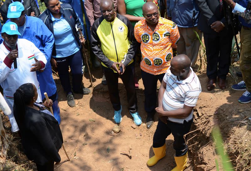 Chairman of Truth and Reconciliation Commission Pierre Claver Ndayicariye addresses delegates near a 1972 mass grave as they prepare to extract bodies in Gikuzi village, Vugizo commune in Makamba Province